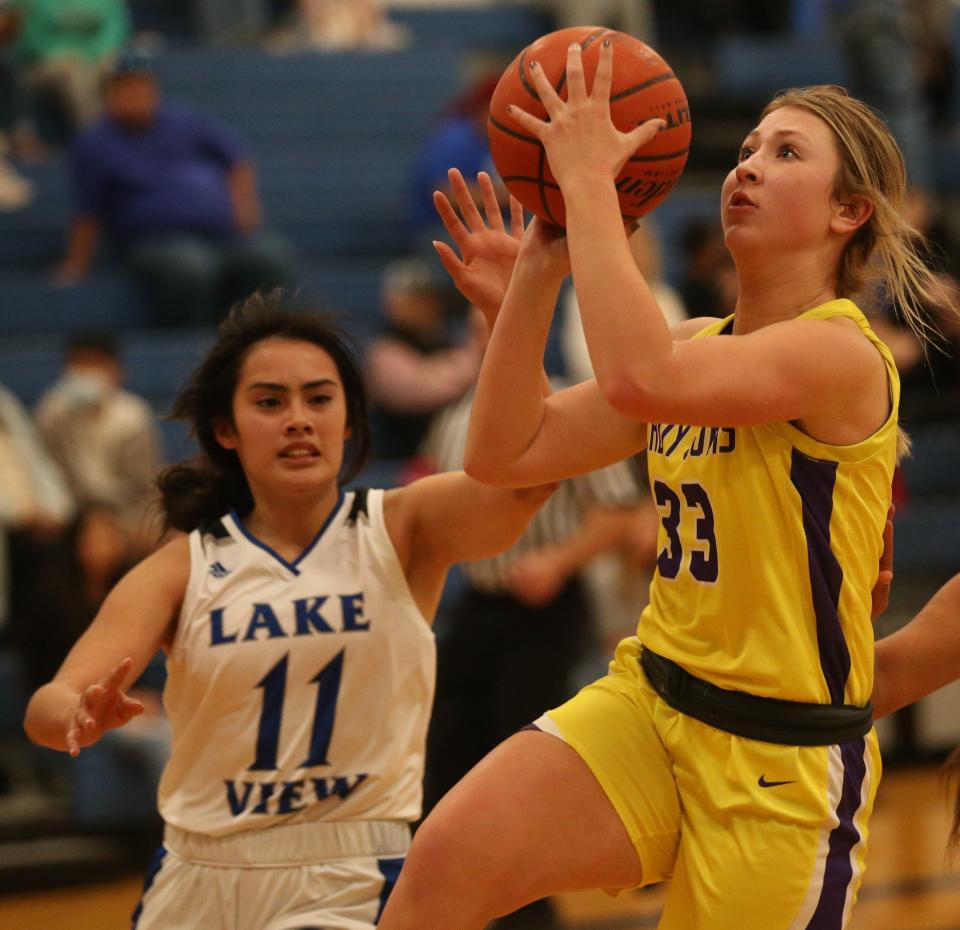 Ozona High School's Claire Bean, right, drives to the basket as Lake View's Myra Pagen closes in during a game at Ben Norton gym on Tuesday, Dec. 7, 2021.