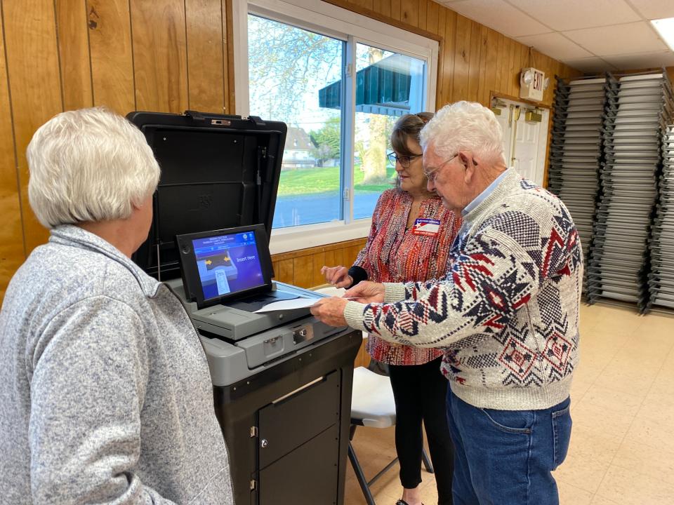 Fred Kahl was the first Washington Township 4 voter at the Zullinger Community Center in the April 23 primary election. He is shown with Judy Reitz, left, judge of elections, and clerk Virginia Johnson.