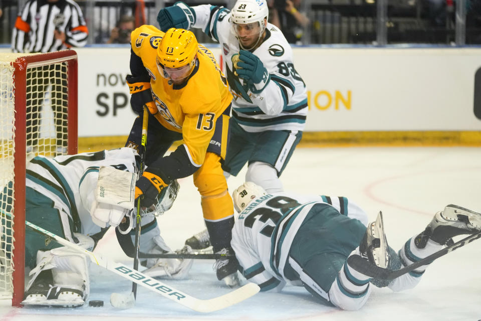 San Jose's goaltender James Reimer, left, makes a save against Nashville's Yakov Trenin during their NHL hockey game between San Jose Sharks and Nashville Predators played in Prague, Czech Republic, Friday, Oct. 7, 2022. (AP Photo/Petr David Josek)