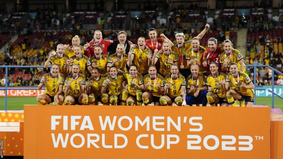 Sweden players celebrate on the podium after coming third at the Women's World Cup