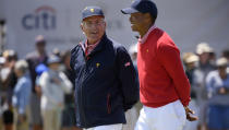 U.S. team player and captain Tiger Woods, right, and Fred Couples walk along the 16th fairway at the Royal Melbourne Golf Club in the opening rounds of the President's Cup golf tournament in Melbourne, Thursday, Dec. 12, 2019. (AP Photo/Andy Brownbill)