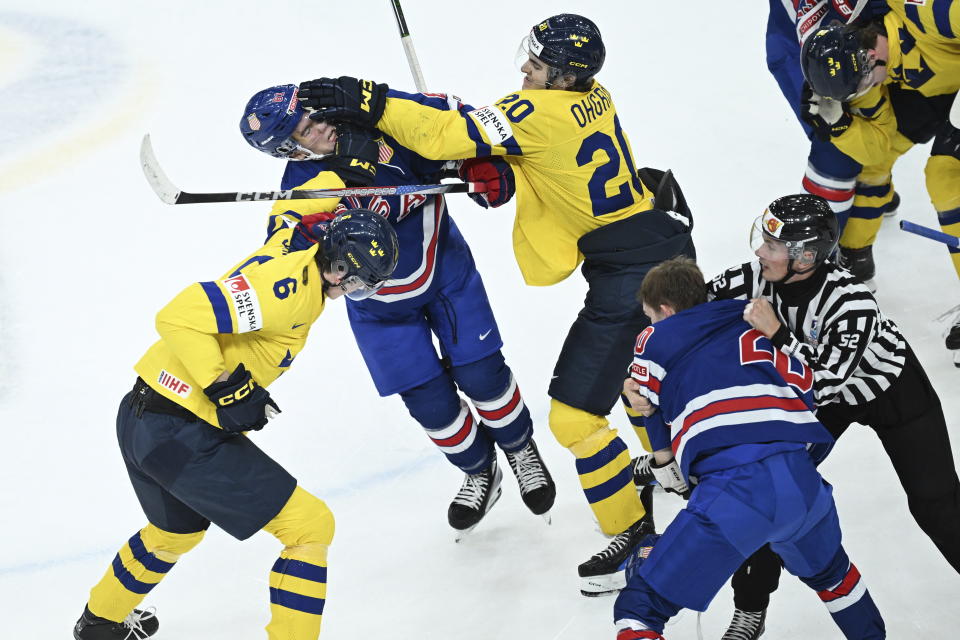 Sweden's Anton Johansson, left, and Liam Ohgren in action against USA's Frank Nazar during the IIHF World Junior Championship ice hockey final match between Sweden and USA at Scandinavium in Gothenburg, Sweden, Friday Jan. 5, 2024. (Bjorn Larsson Rosvall/TT via AP)