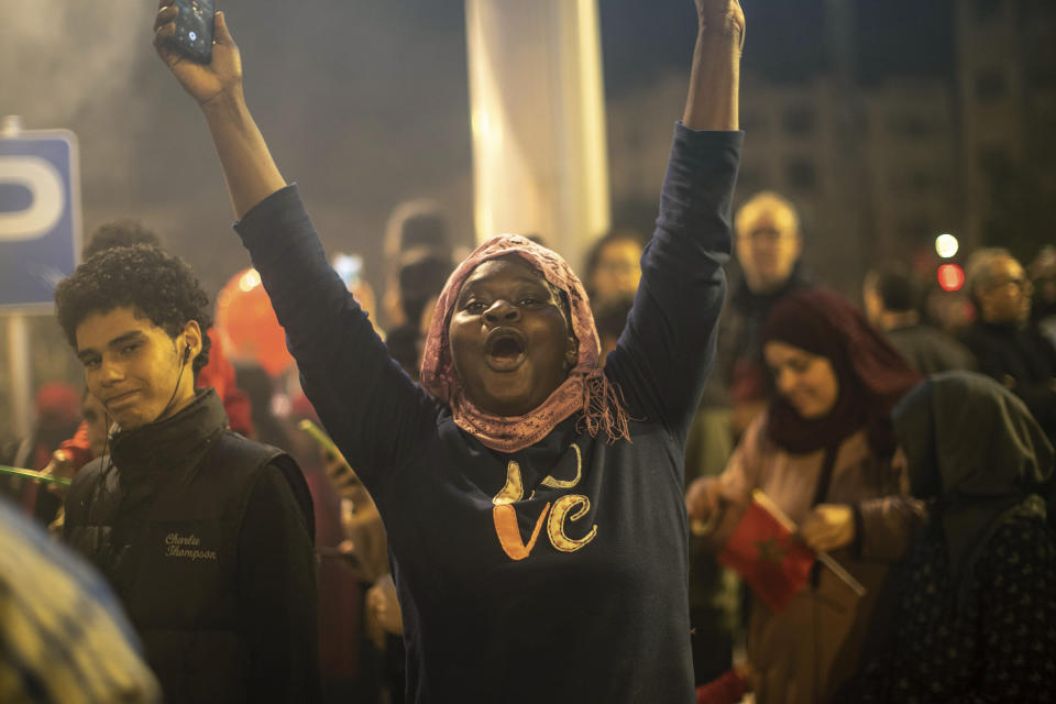 A Senegalese woman celebrates Morocco's win over Spain in a World Cup match played in Qatar, in Rabat, Morocco, Tuesday, Dec. 6, 2022. For many, Morocco’s underdog performance is the best story in the World Cup so far, with the hopes of the African continent soaring ahead of the match on Saturday against Portugal. Across the continent of more than 1 billion people, African fans are excited that Morocco has become the fourth team from an African country to ever qualify for the World Cup quarterfinals, and the first in a dozen years. (AP Photo/Mosa'ab Elshamy)