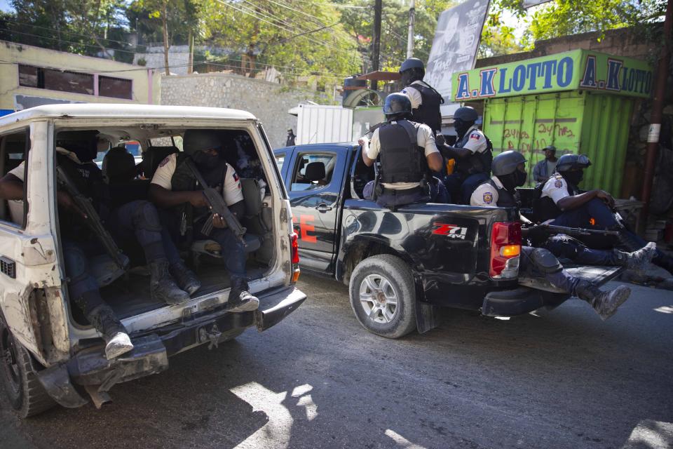 FILE - Police patrol after recovering the bodies of at least two journalists slain by gangs in Port-au-Prince, Haiti, Jan. 7, 2022. Canadian Prime Minister Justin Trudeau said immediate action is needed to fix the security situation in Haiti and that additional aid is a central topic of a virtual meeting Friday, Jan. 21, 2022 that includes cabinet officials from Canada, the United States, France and other countries. (AP Photo/Odelyn Joseph, File)