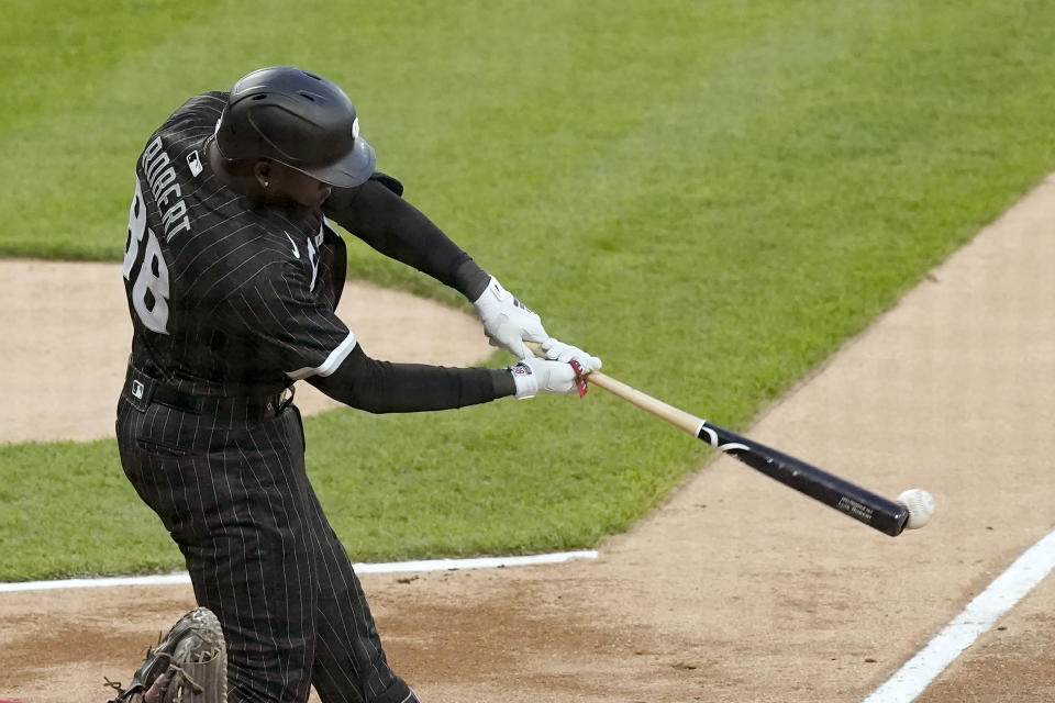 Chicago White Sox's Luis Robert singles off Cleveland Guardians starting pitcher Zach Plesac during the first inning of a baseball game Monday, May 9, 2022, in Chicago. (AP Photo/Charles Rex Arbogast)