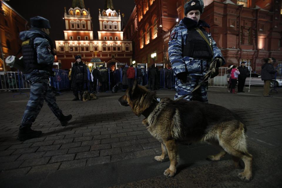 Russian police officers get ready to check people arriving at the Red Square ahead of the New Year's Eve festivities, in Moscow, Russia, Tuesday, Dec. 31, 2013. Russian authorities ordered police to beef up security at train stations and other facilities across the country after a suicide bomber killed 14 people on a bus Monday in the southern city of Volgograd. It was the second deadly attack in two days on the city that lies just 400 miles (650 kilometers) from the site of the 2014 Winter Olympics. (AP Photo/Pavel Golovkin)