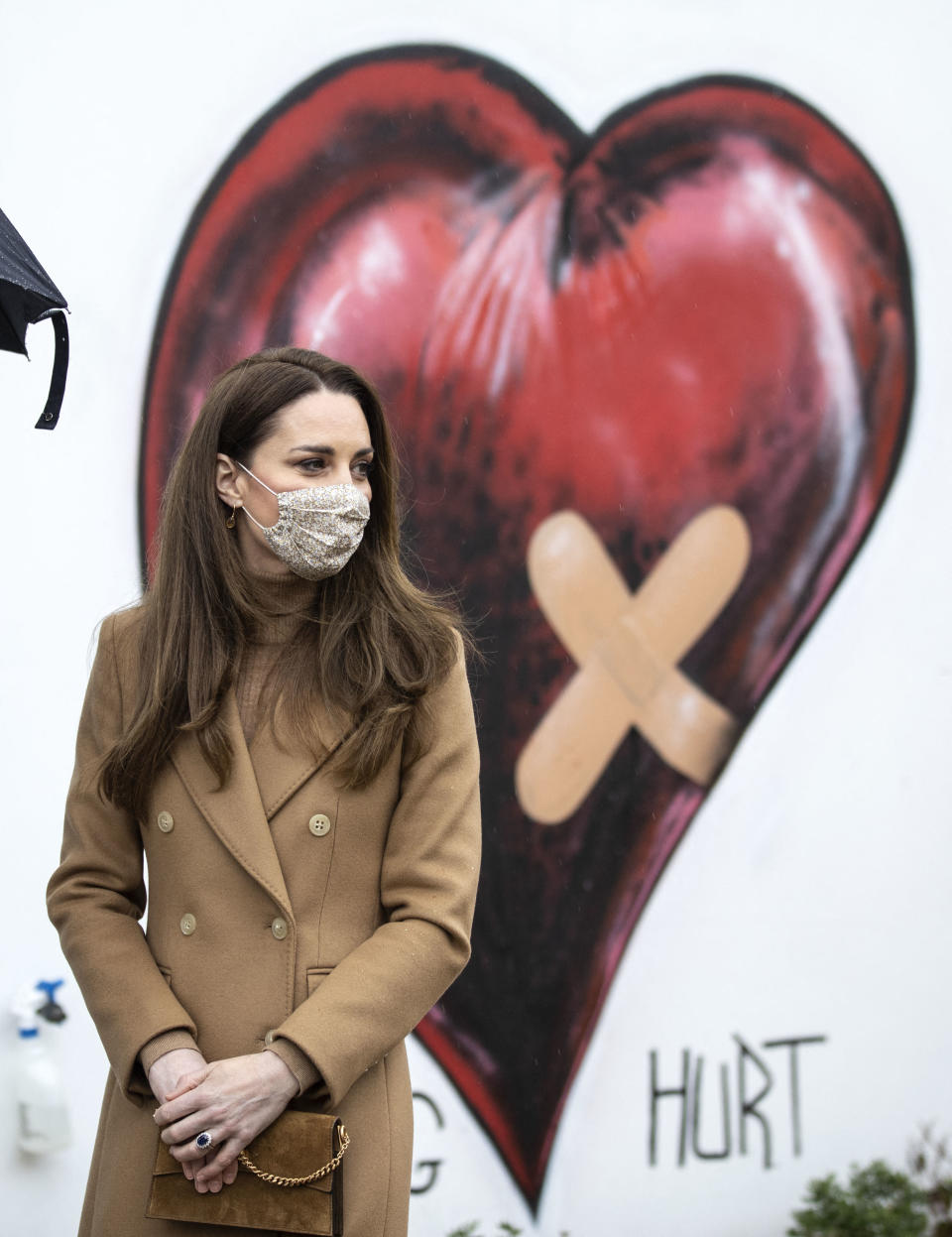 Britain's Catherine, Duchess of Cambridge, wearing a face covering due to Covid-19, meets with members of the ambulance service in the wellbeing garden during a visit to Newham Ambulance Station in east London on March 18, 2021. (Photo by RICHARD POHLE / POOL / AFP) (Photo by RICHARD POHLE/POOL/AFP via Getty Images)