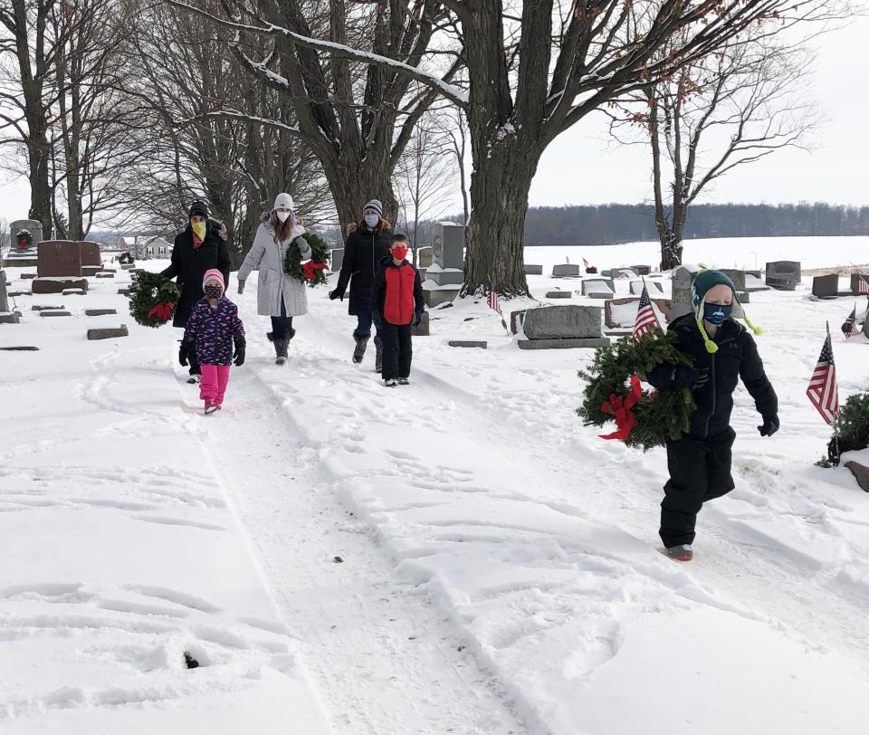 In this file photo, youngsters and their families braved the snow and cold to help place wreaths on the graves of veterans in South Farmington Friends Cemetery.