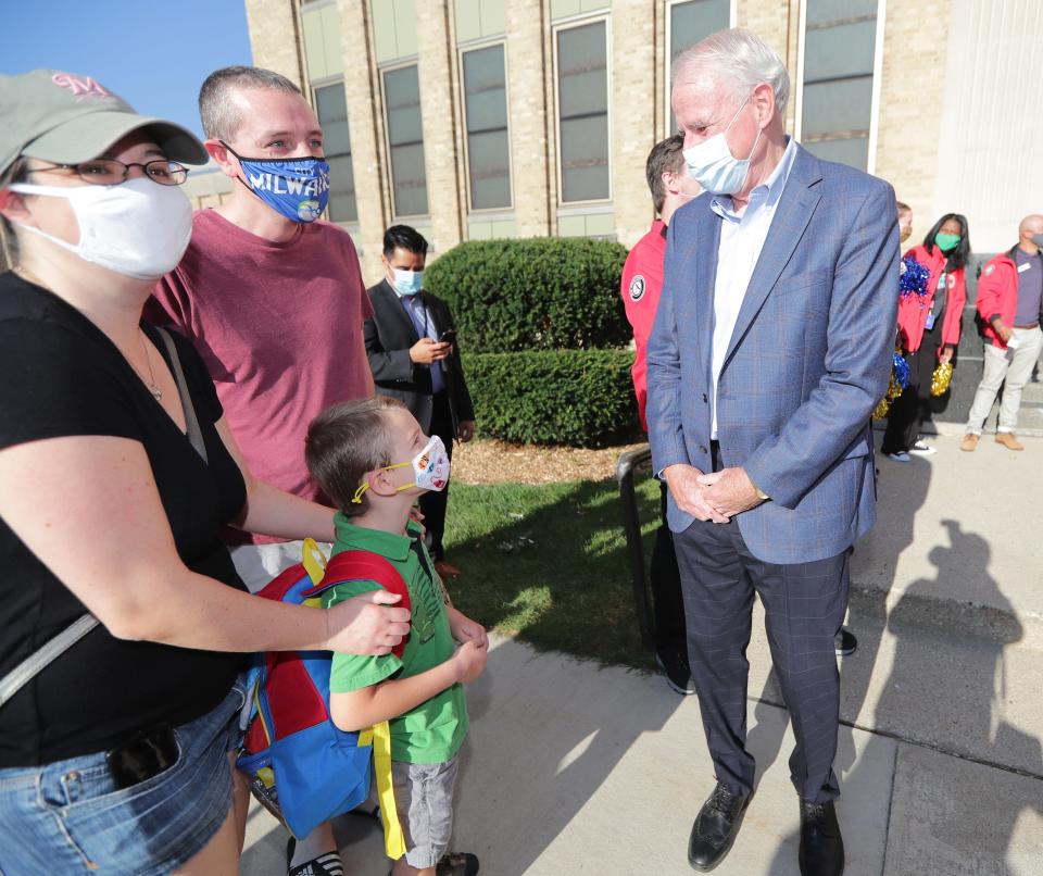 Mayor Tom Barrett talks with first grader Eric Wright and his parents, Josh and Jenny Wright, during the first day of school at MacDowell Montessori School on Aug. 16.