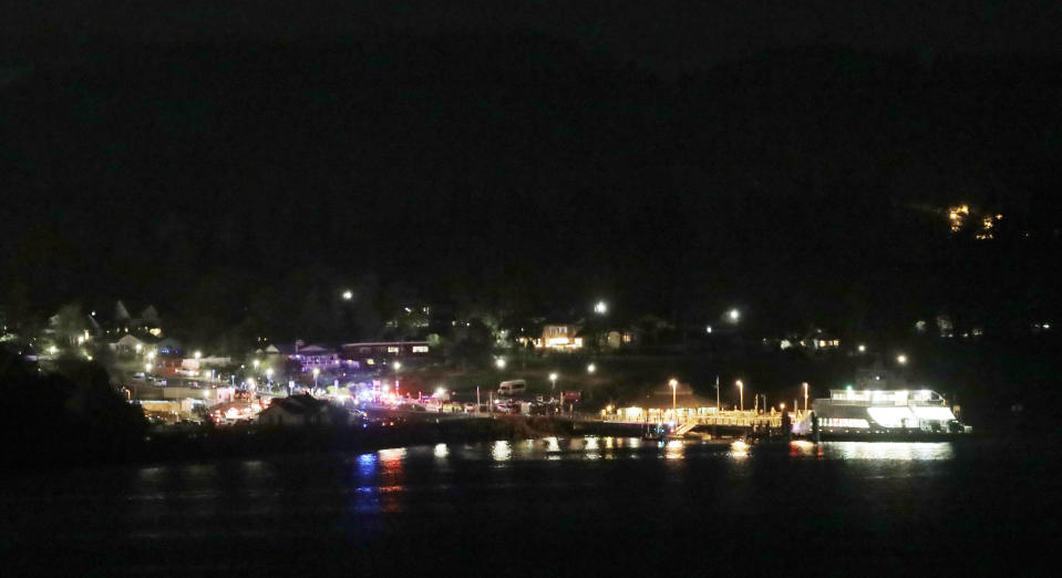 Law enforcement vehicles are shown, Friday, Aug. 10, 2018, at the ferry terminal in Steilacoom, Wash., near where a Coast Guard spokeswoman said the agency was responding to a report of a smoke plume and possible plane crash. Earlier in the evening, officials at Seattle-Tacoma International Airport said an Alaska Airlines plane had been stolen and later crashed. (AP Photo/Ted S. Warren)