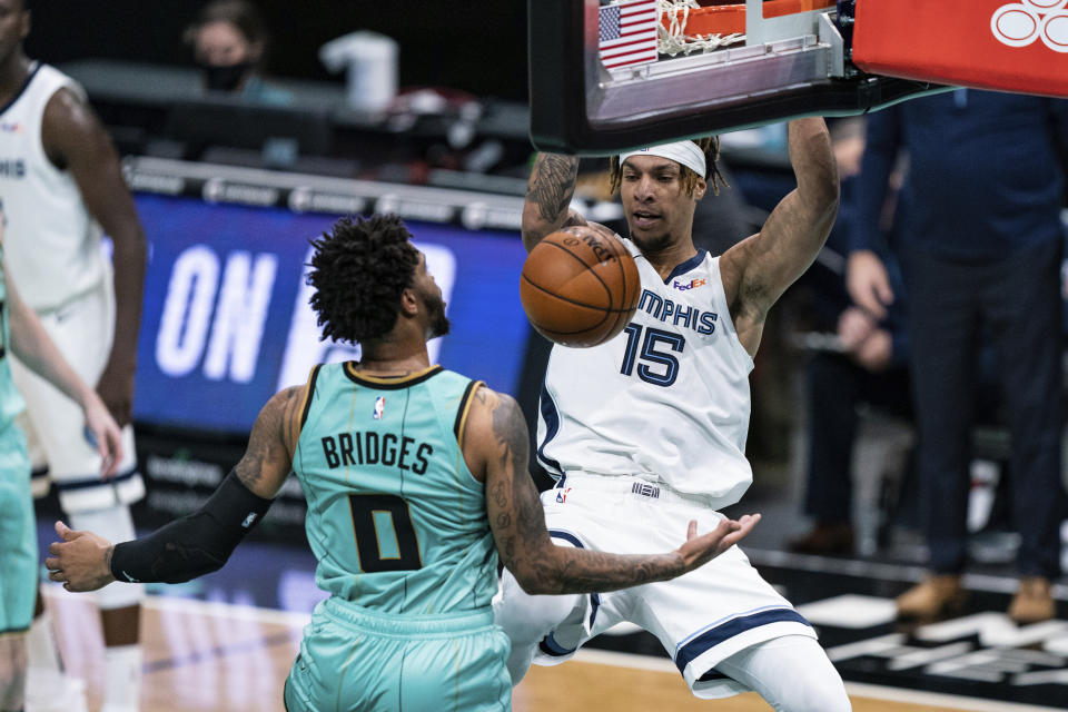 Memphis Grizzlies forward Brandon Clarke (15) dunks in front of Charlotte Hornets forward Miles Bridges (0) during the second half of an NBA basketball game in Charlotte, N.C., Friday, Jan. 1, 2021. (AP Photo/Jacob Kupferman)