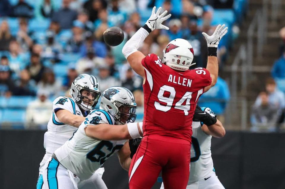 Cardinals defensive lineman Zach Allen, right, stretches out to block a pass by Panthers quarterback Baker Mayfield during the game against the Cardinals on Sunday, October 2, 2022, 2022 in Charlotte, NC. The Panthers lost 26-16.