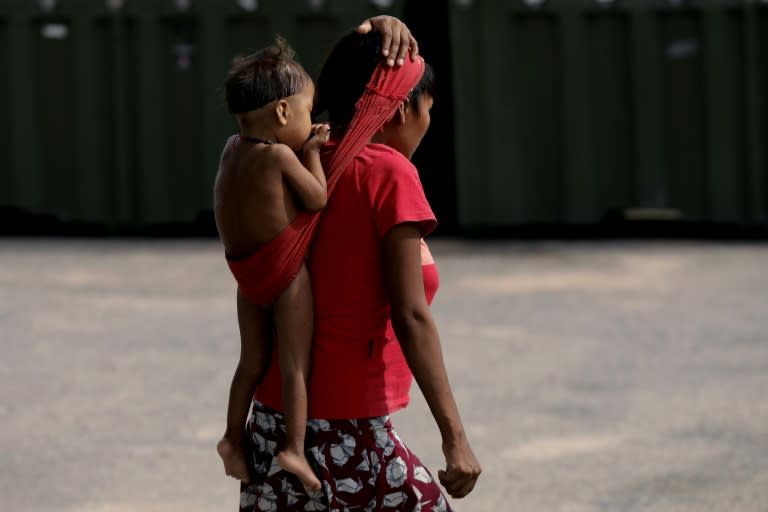 Une femme du peuple indigène Yanomami, un enfant sur le dos, dans l'enceinte de de l'hôpital de campagne de l'armée de l'Air à Boavista, dans l'Etat de Roraima, le 27 janvier 2023 au Brésil (MICHAEL DANTAS)