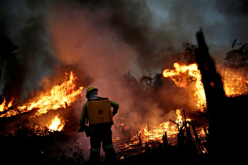 FILE PHOTO: A IBAMA fire brigade member attempts to control a fire in a tract of the Amazon jungle in Apui