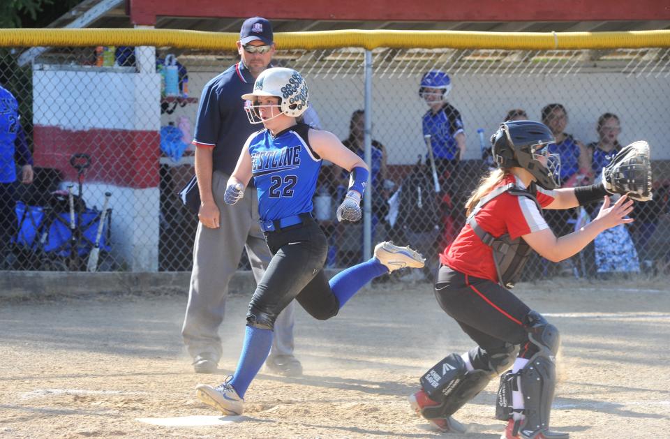 Crestline's Maddie Engler scores off an RBI single.