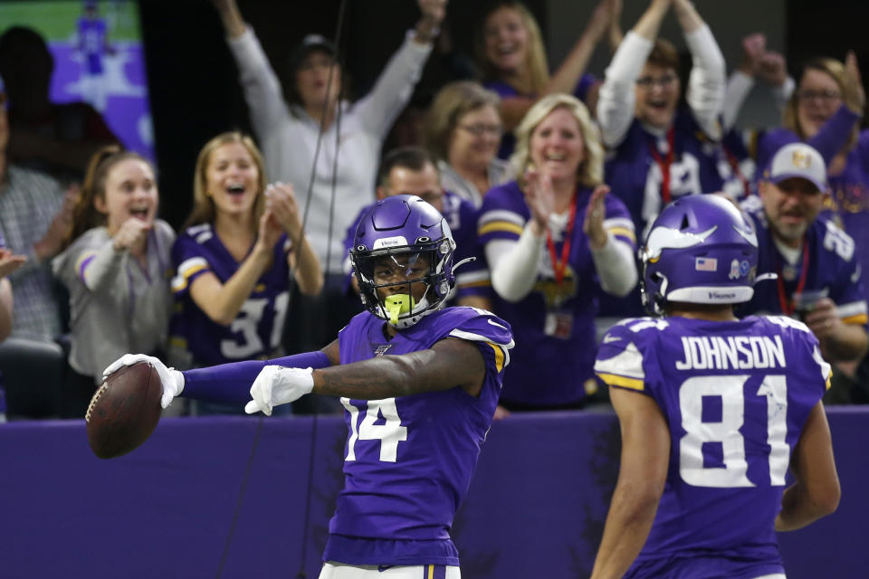 Minnesota Vikings wide receiver Stefon Diggs (14) celebrates with teammate Bisi Johnson, right, after catching a 54-yard touchdown pass during the second half of an NFL football game against the Denver Broncos, Sunday, Nov. 17, 2019, in Minneapolis. (AP Photo/Jim Mone)
