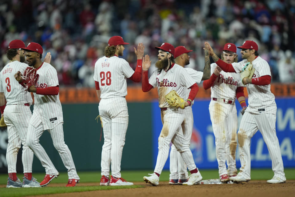 Members of the Philadelphia Phillies celebrate after winning a baseball game against the San Francisco Giants, Sunday, May 5, 2024, in Philadelphia. (AP Photo/Matt Rourke)