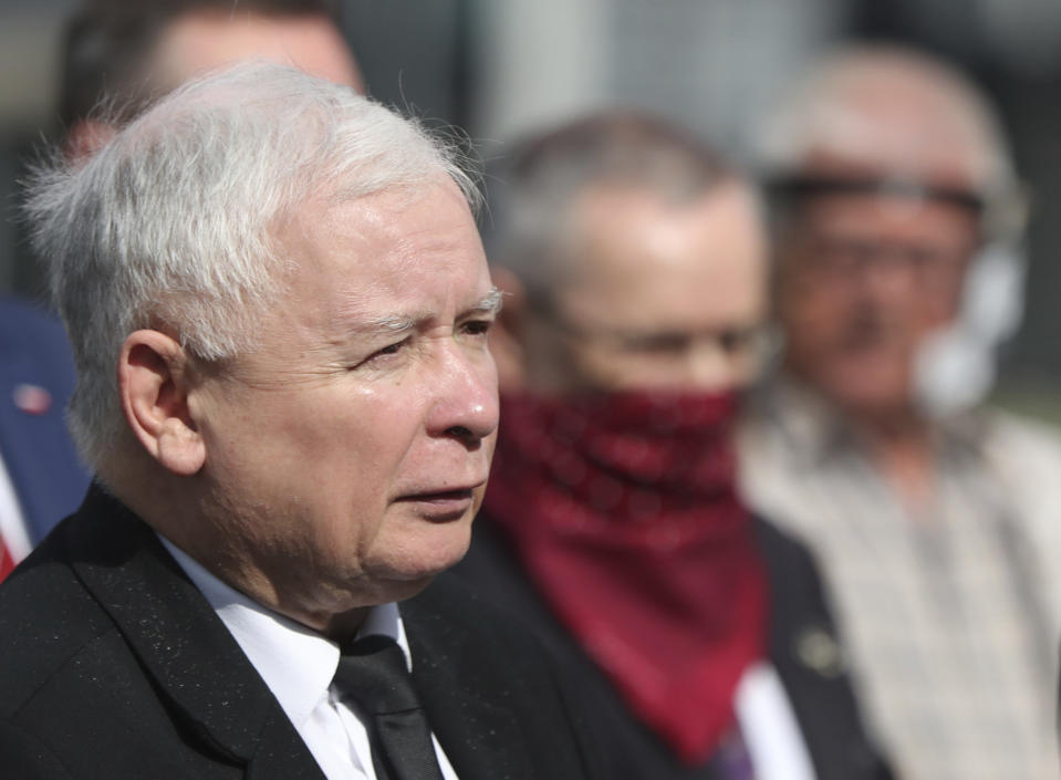 Poland's ruling party leader Jaroslaw Kaczynski, left, during a police-guarded ceremony in Warsaw, Poland, Friday, July 10, 2020 remembering his twin brother, the late president Lech Kaczynski and 95 others, killed in a plane crash in Russia in the year 2010. Friday was the last day of campaigning in Poland's presidential election runoff in which incumbent president, Andrzej Duda enjoys the right-wing ruling party's backing for a reelection, rivalling liberal Warsaw mayor, Rafal Trzaskowski. Opinion polls suggest the election may be decided by a small number of votes.(AP Photo/Czarek Sokolowski)