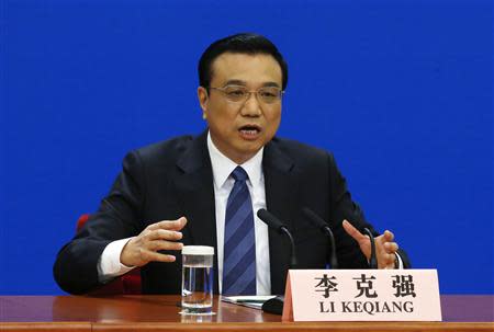 China's Premier Li Keqiang gestures as he speaks during a news conference, after the closing ceremony of the Chinese National People's Congress (NPC) at the Great Hall of the People, in Beijing March 13, 2014. REUTERS/Barry Huang