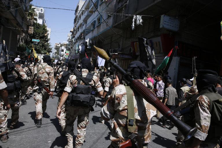 Palestinian Islamic Jihad militants parade down a street in downtown Gaza City on August 29, 2014