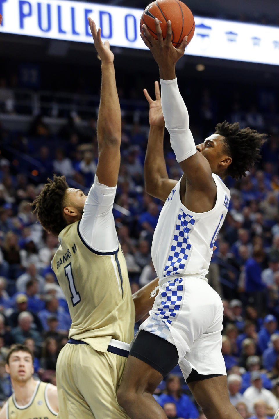 Kentucky's Ashton Hagans, right, shoots while pressured by Georgia Tech's James Banks III, left, during the first half of an NCAA college basketball game in Lexington, Ky., Saturday, Dec. 14, 2019. (AP Photo/James Crisp)