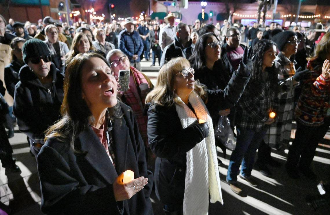 Mona Lynch-Kaolelopono, bottom left, joins in song as the community gathers at a vigil in Veterans Park for slain Selma officer Gonzalo Carrasco Jr. Thursday, Feb 2, 2023 in Selma.
