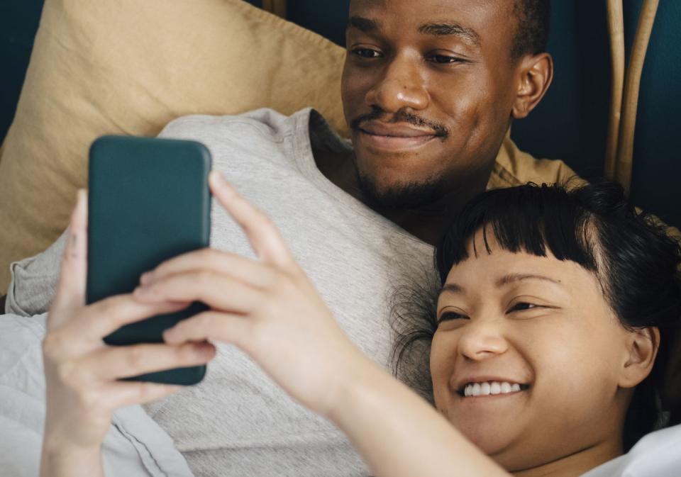 a man and a woman looking at a cell phone