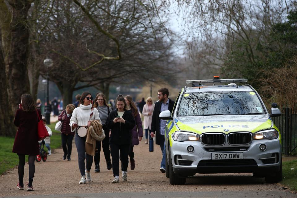 <p>People walk past a police car parked at Hyde Park</p> (Getty Images)