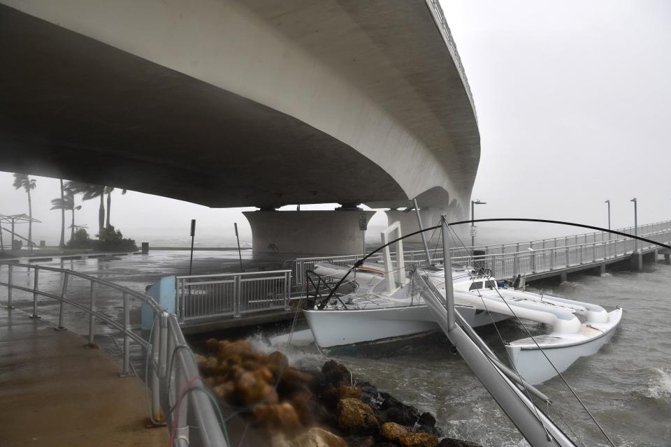 A trimaran sailboat was pushed by winds from Tropical Storm Nicole into the Tony Saprito Pier along the John Ringling Causeway in Sarasota, Florida on Thursday, Nov. 10, 2022. 