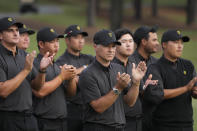 International team captain Trevor Immelman and the team celebrate the USA team's victory after a singles match at the Presidents Cup golf tournament at the Quail Hollow Club, Sunday, Sept. 25, 2022, in Charlotte, N.C. (AP Photo/Chris Carlson)