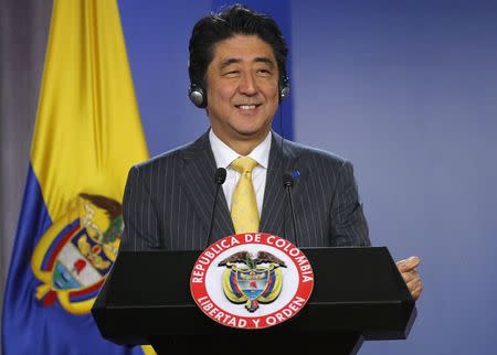 Japan's Prime Minister Shinzo Abe smiles during a news conference at the presidential palace in Bogota July 29, 2014. Abe is on a one-day official visit to Bogota. REUTERS/John Vizcaino