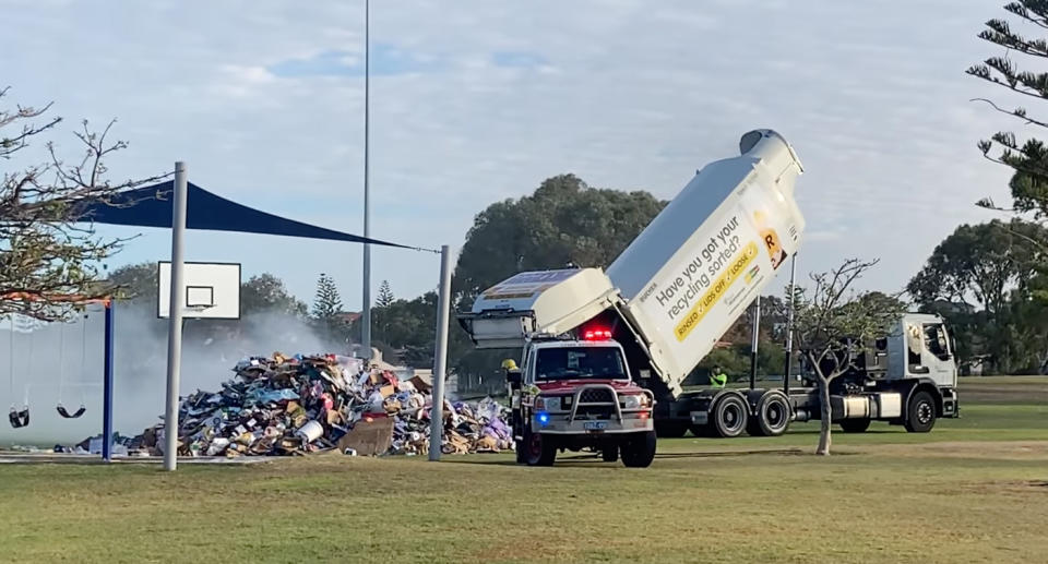 City of Wanneroo's garbage truck dumping pile of rubbish on a basketball court in a park after it caught fire. 