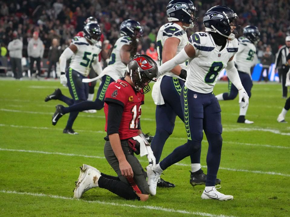 Tom Brady reacts after an attempted trick play results in an interception.