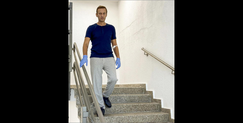 In this photo taken from a video published by Russian opposition leader Alexei Navalny on his instagram account, Russian opposition leader Alexei Navalny walks down stairs in a hospital in Berlin, Germany, Saturday, Sept. 19, 2020. Navalny, who is being treated in a German hospital for suspected poisoning by a nerve agent, says on social media that he is recovering verbal and physical abilities despite despairing at first. (Navalny Instagram via AP)