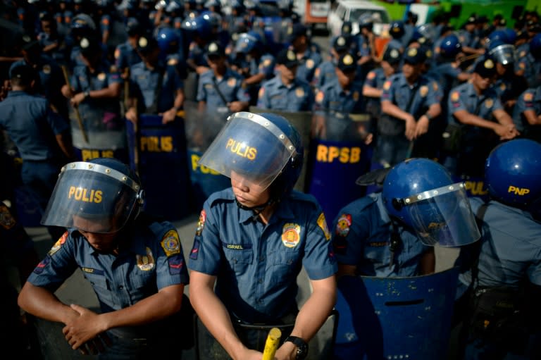 Policeman secure the perimeter of the House of Representatives where Philippine President Rodrigo Duterte was delivering his State of the Nation address in Manila on July 25, 2016