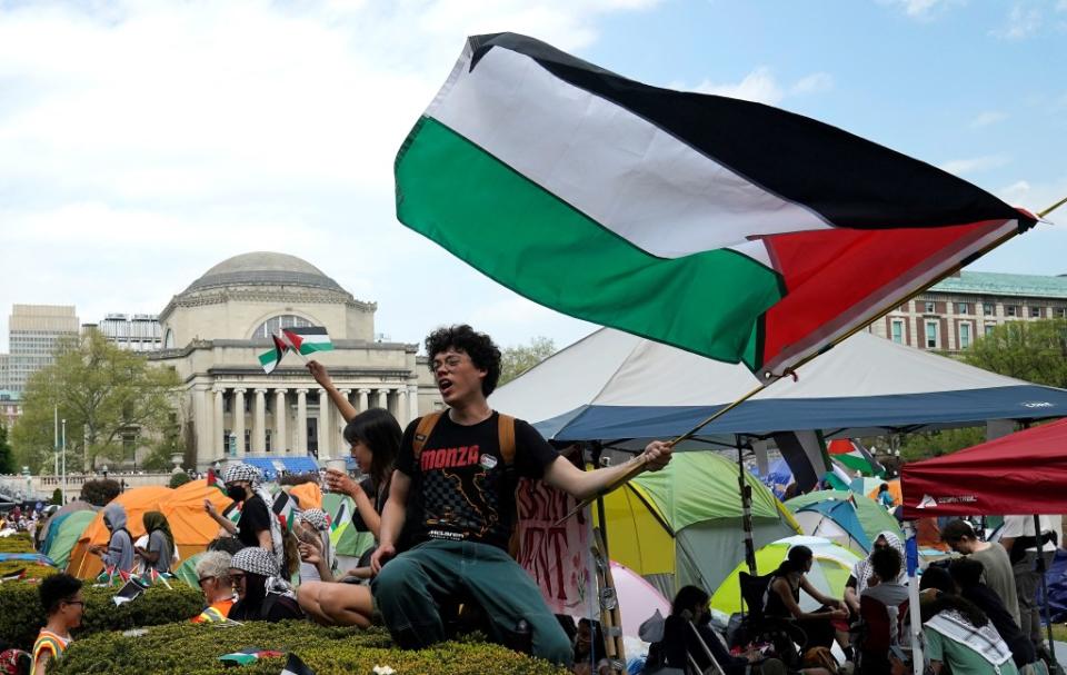 An anti-Israel protester sits on the West Lawn of Columbia University on April 29, 2024. AFP via Getty Images