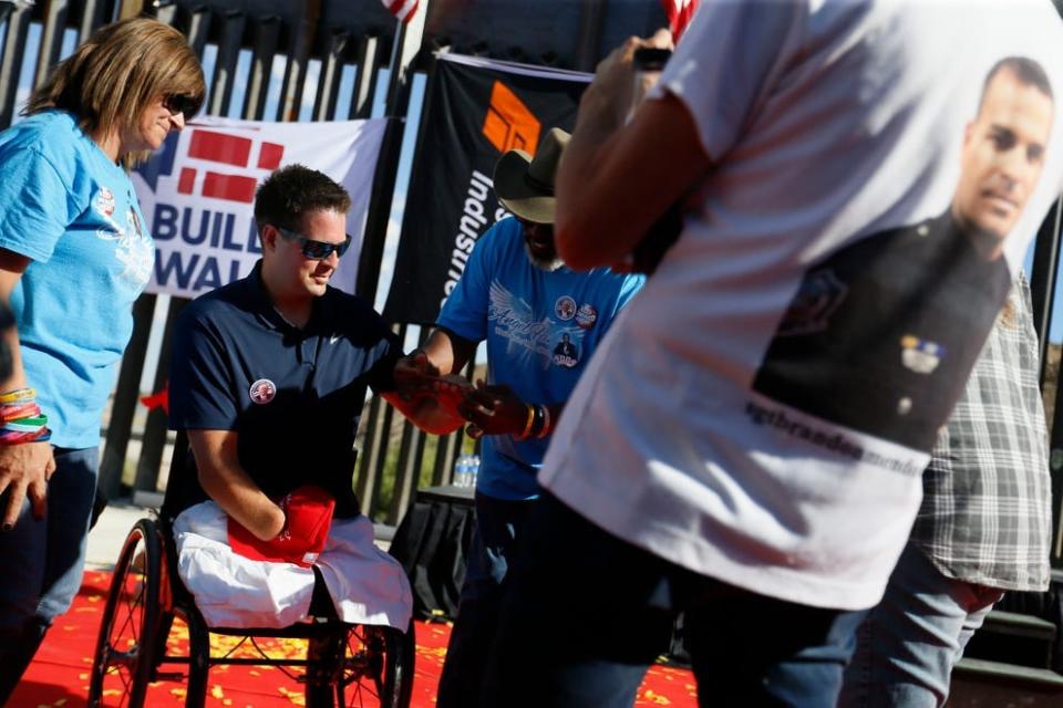 Brian Kolfage, the founder of We Build The Wall, is given wrist bands from "Angel Families" at a press conference May 30, 2019, in Sunland Park, New Mexico. A co-defendant in a federal fraud and money laundering case connected with We Build The Wall is continuing to try to have his trial separated from Kolfage.