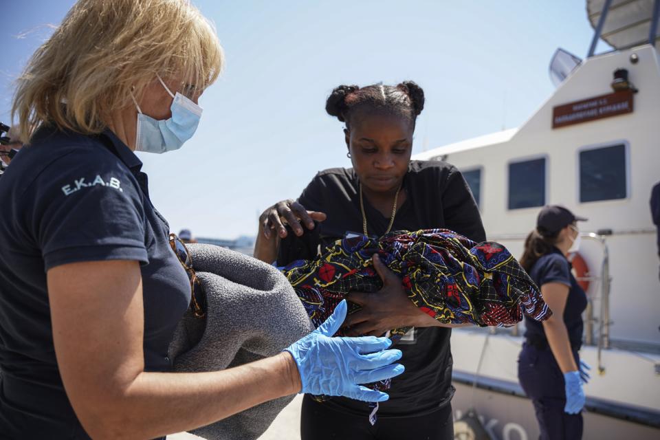 A migrant woman carries a newborn boy at Mytilene port, on the northeastern Aegean Sea island of Lesbos, Greece, Wednesday, June 22, 2022. Authorities in Greece say a woman from Eritrea has given birth on an uninhabited rocky islet after traveling from nearby Turkey with other migrants. A coast guard official said 30 adult Eritreans ‒ 25 men and five women ‒ were spotted during a patrol near Lesbos. (AP Photo/Panagiotis Balaskas)