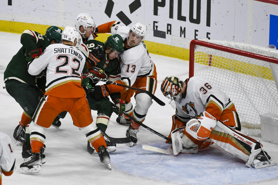 Minnesota Wild left wing Kirill Kaprizov, third from right, tries to push past Anaheim Ducks defensemen Kevin Shattenkirk (22) and Simon Benoit (13) to get a shot past goalie John Gibson (36) during the third period of an NHL hockey game Saturday, Dec. 3, 2022, in St. Paul, Minn. The Wild win 5-4 in a shootout. (AP Photo/Craig Lassig)