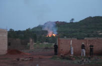 <p>Fire can be seen by the swimming pool of the Campement Kangaba, a tourist resort near Bamako, Mali, Sunday, June 18, 2017. Suspected jihadists attacked the hotel resort Sunday in Mali’s capital, taking hostages at a spot popular with foreigners on the weekends. (AP Photo/Baba Ahmed) </p>