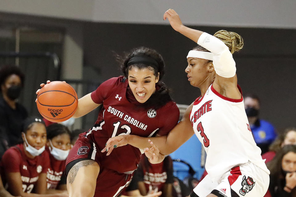 South Carolina's Brea Beal (12) tries to drive the ball around North Carolina State's Kai Crutchfield (3) during the second half of an NCAA college basketball game, Tuesday, Nov. 9, 2021 in Raleigh, N.C. (AP Photo/Karl B. DeBlaker)