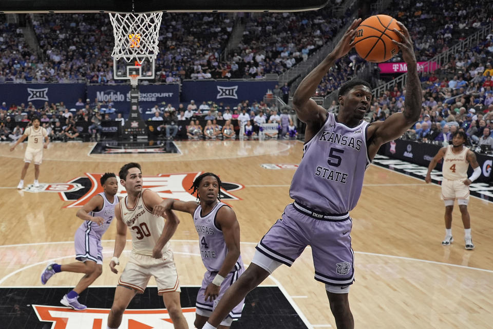 Kansas State guard Cam Carter (5) grabs a rebound during the second half of an NCAA college basketball game against Texas Wednesday, March 13, 2024, in Kansas City, Mo. Kansas State won 78-74. (AP Photo/Charlie Riedel)