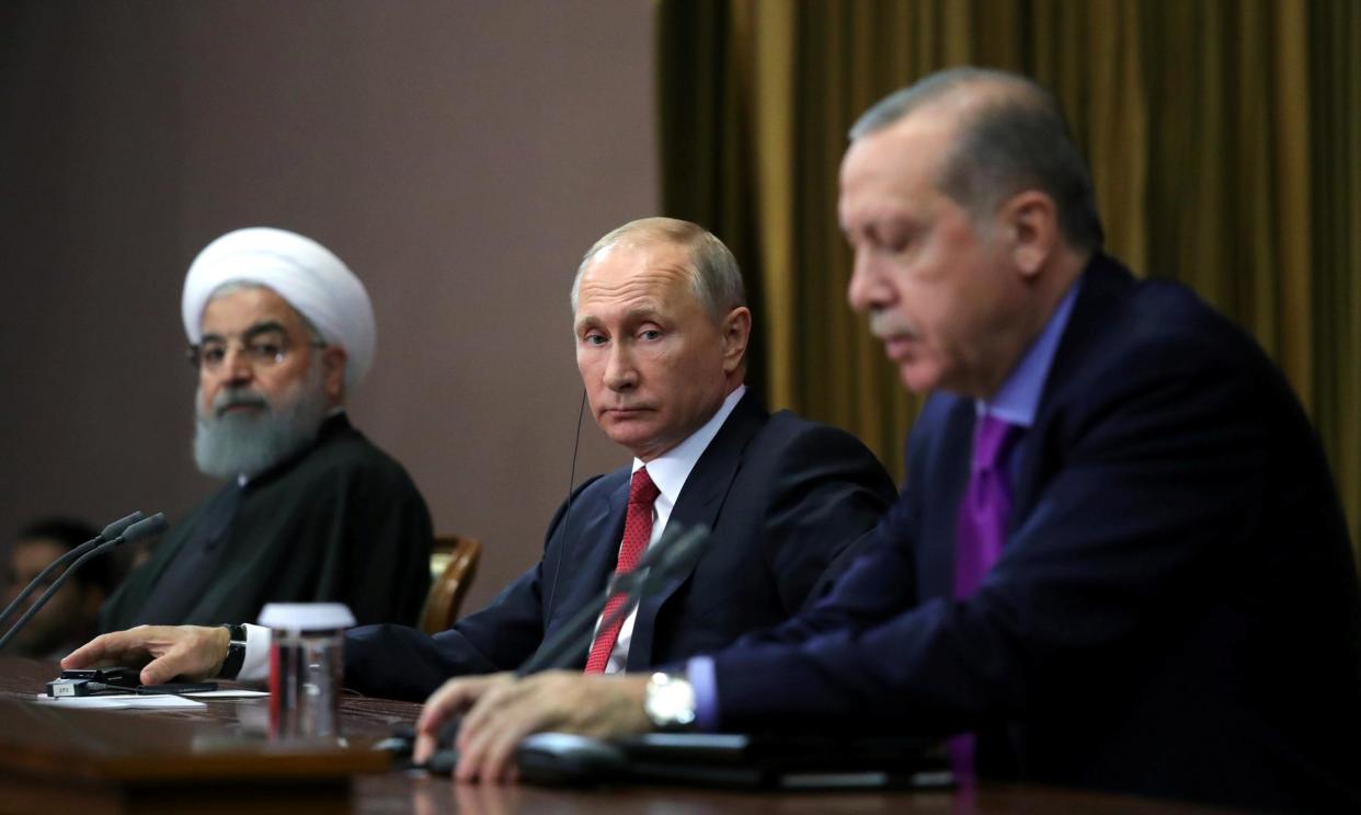 Russian President Vladimir Putin is flanked by Iranian President Hassan Rouhani (l) and Turkish Premier Recip Tayyip Erdogan at the Sochi summit this week: Reuters