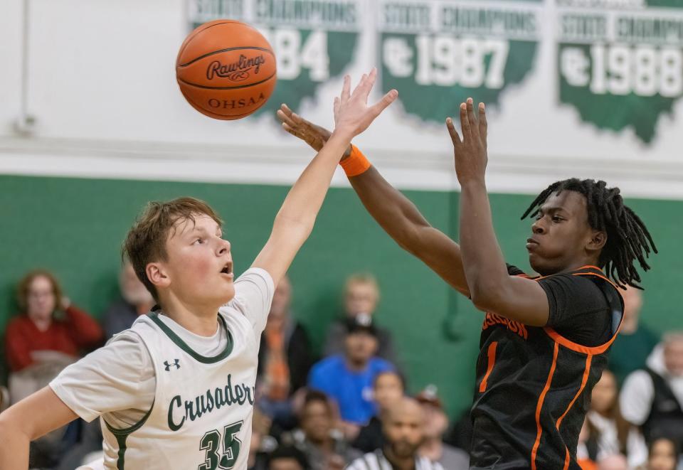 Massillon’s Jadyce Thigpen makes a pass around Central Catholic’s Will Minor during Friday's game.