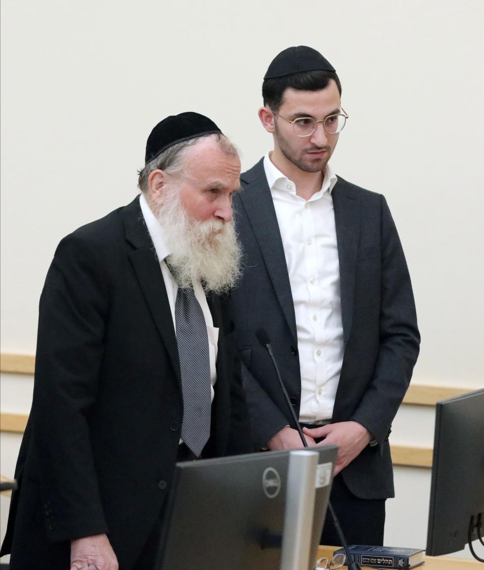 Rabbi Nathanial Sommer, second from right and his son, Aaron Sommer, right, stand with their attorneys Akiva Goldberg, left and Jacob Laufer, during their sentencing at the Rockland County Courthouse in New City, Sept. 20, 2023.