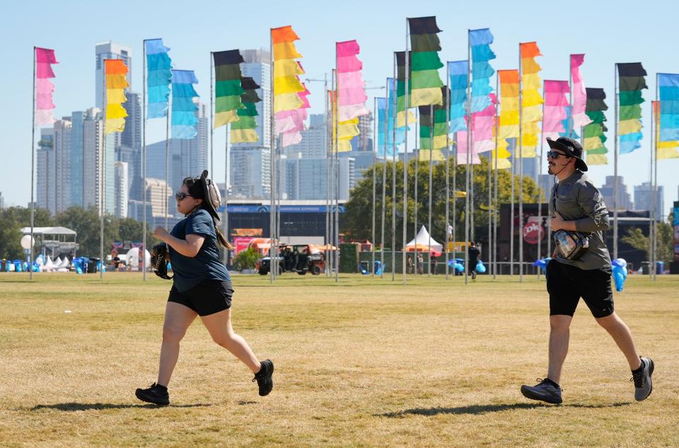 Samantha Salazar and Nacho Alanis, of Corpus Christi, run toward the Honda Stage when the gates opened at the Austin City Limits Music Festival in Zilker Park Friday October 4, 2024. Later in the day, Foster The People and Blink 182 will perform on the stage.