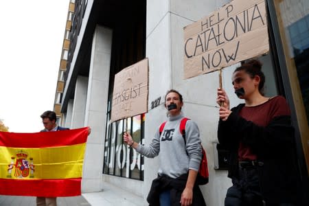 Protesters demonstrate outside the venue where Former Catalan President Carles Puigdemont held a news conference in Brussels