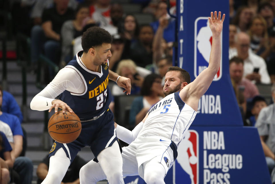 Denver Nuggets guard Jamal Murray (27) collides with Dallas Mavericks guard J.J. Barea (5) and is called for an offensive foul during the second half of an NBA basketball game Wednesday, March 11, 2020, in Dallas. The Mavericks won 113-97. (AP Photo/Ron Jenkins)