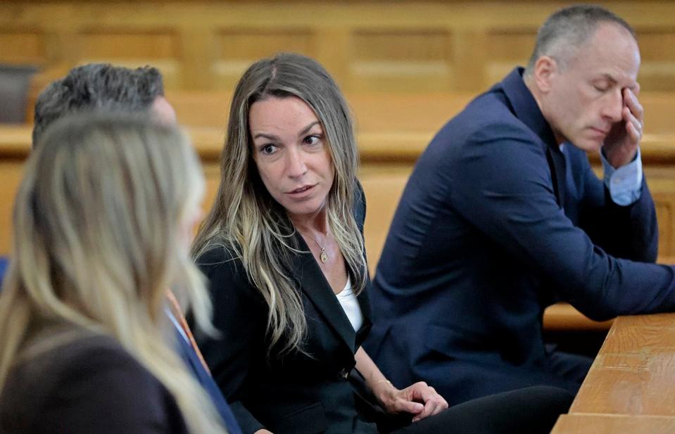 Karen Read talks with her legal team at the Norfolk Superior Court in Dedham, Mass., Monday, July 1, 2024. This is their fifth day of deliberations in the murder trial for Read. Read is accused of backing her SUV into her Boston Police officer boyfriend, John O'Keefe, and leaving him to die in a blizzard in Canton, in 2022. (Pat Greenhouse/The Boston Globe via AP, Pool)