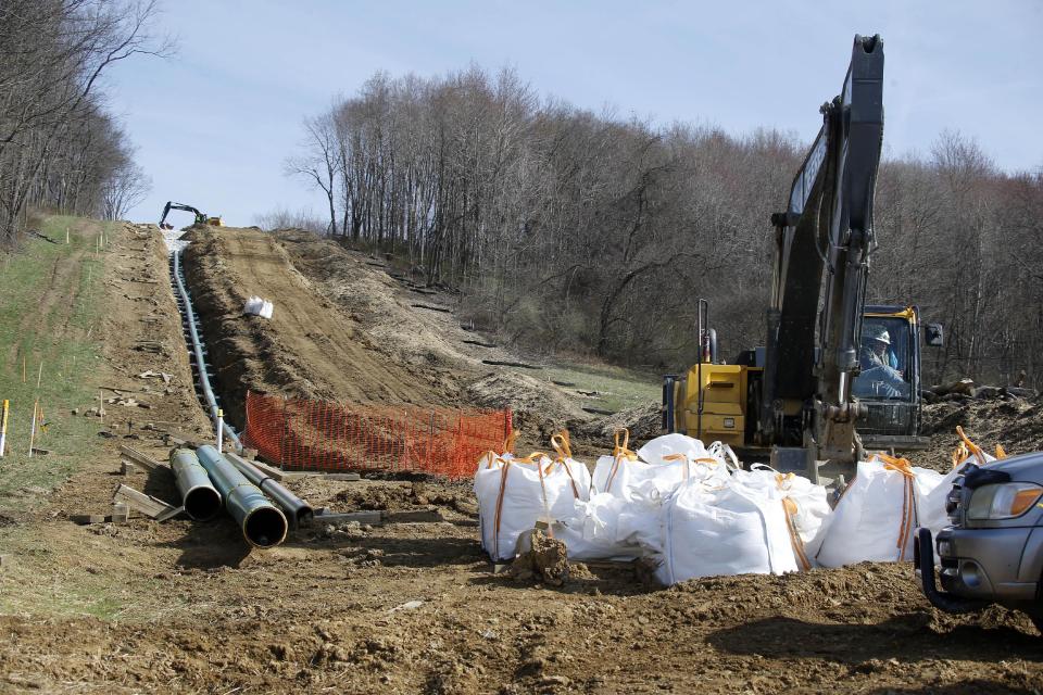 In this April 17, 2014 photo, workers continue the construction at a gas pipeline site in Harmony, Pa. Dennis Martire, from the Laborers’ International Union, or LIUNA, said that the man-hours of union work on large pipeline jobs in Pennsylvania and West Virginia have increased by more than 14 times since 2008. (AP Photo/Keith Srakocic)